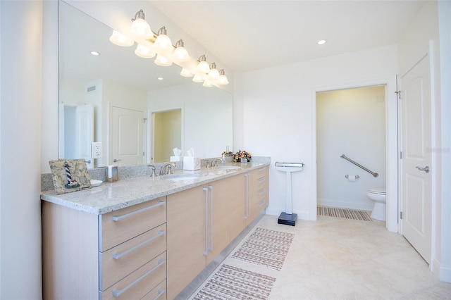 bathroom featuring vanity and toilet