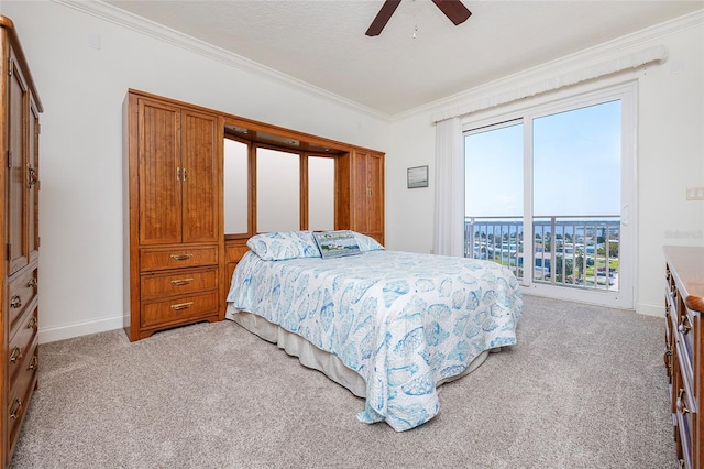 carpeted bedroom with ceiling fan, a textured ceiling, and ornamental molding