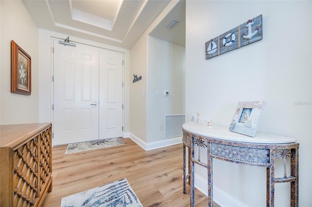 entryway featuring hardwood / wood-style flooring and a textured ceiling