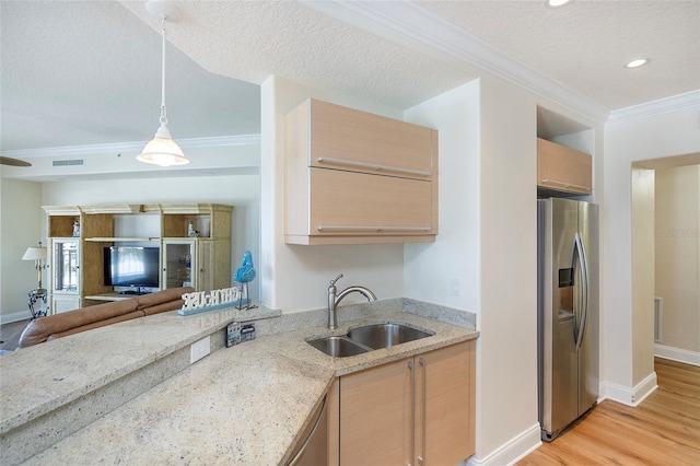 kitchen featuring light stone countertops, light brown cabinets, sink, stainless steel fridge with ice dispenser, and light hardwood / wood-style flooring