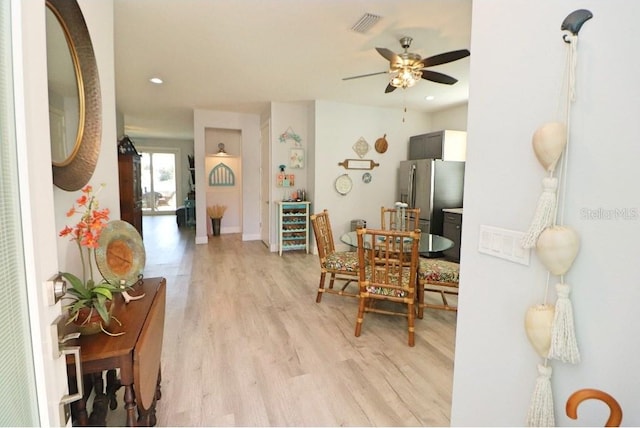 interior space with wine cooler, ceiling fan, and light hardwood / wood-style floors