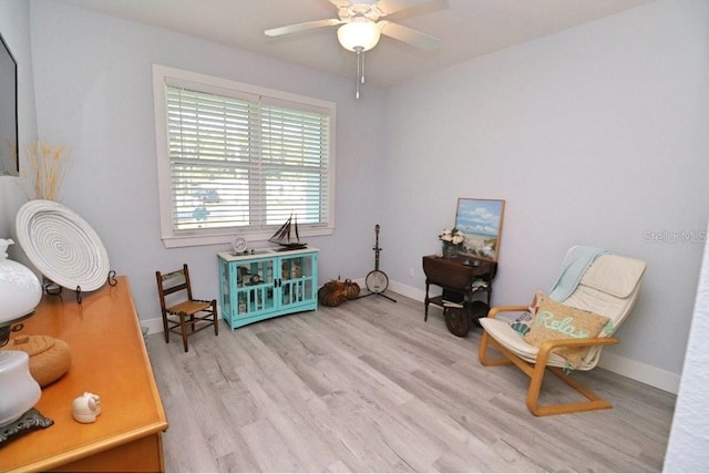 living area featuring ceiling fan and light hardwood / wood-style flooring