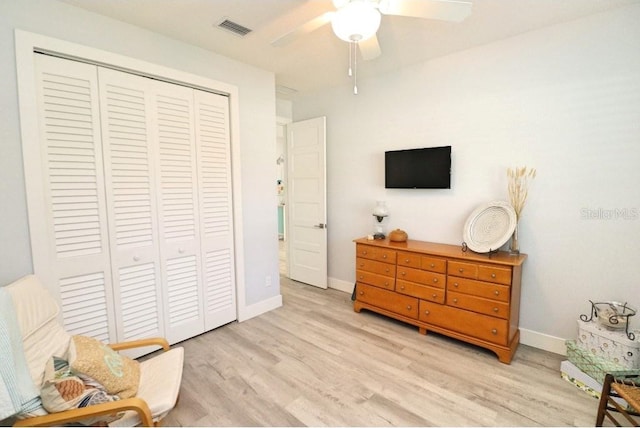 living area with ceiling fan and light wood-type flooring