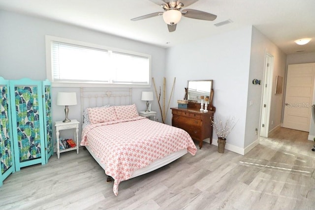 bedroom with ceiling fan and light hardwood / wood-style floors