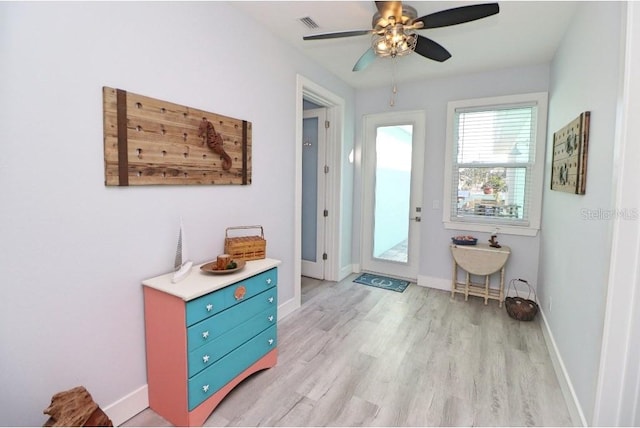 doorway to outside featuring ceiling fan and light wood-type flooring