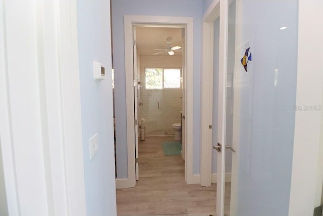 corridor with light hardwood / wood-style flooring