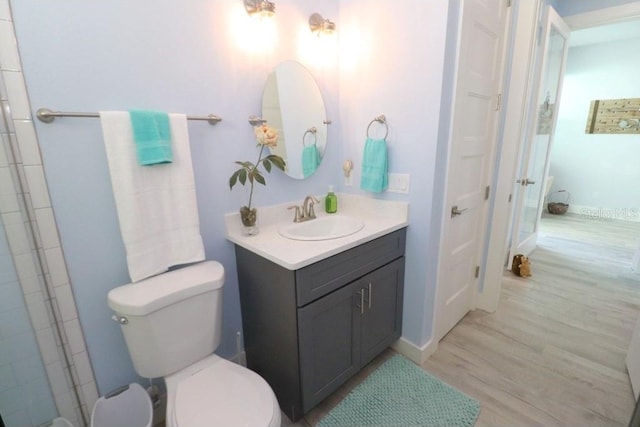 bathroom featuring hardwood / wood-style floors, vanity, and toilet