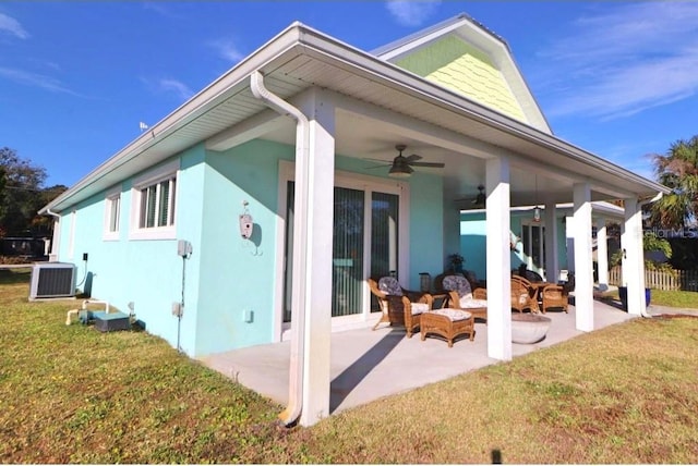 back of property with outdoor lounge area, a lawn, cooling unit, ceiling fan, and a patio area