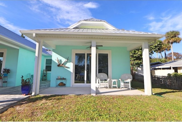 back of house with a patio area, ceiling fan, and a yard