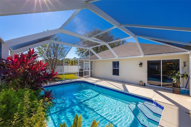 view of swimming pool with a patio area and a lanai