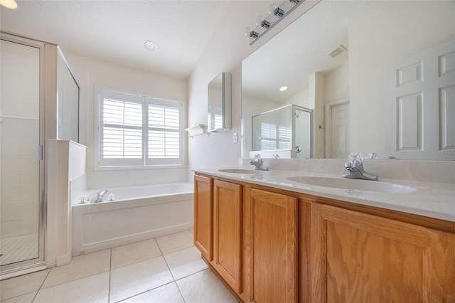 bathroom featuring tile patterned floors, separate shower and tub, vanity, and a textured ceiling