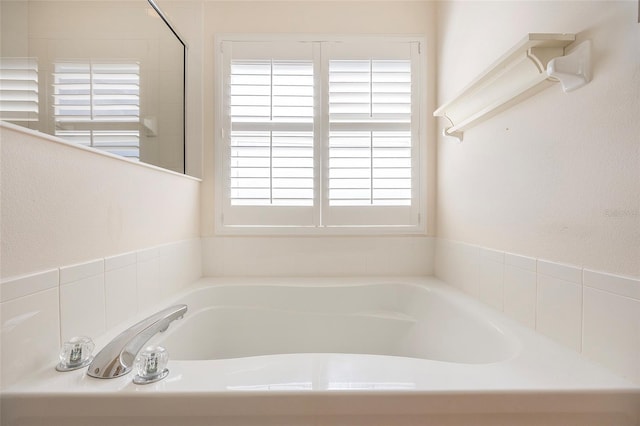 bathroom with a bathtub and a healthy amount of sunlight