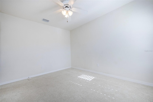 carpeted spare room with ceiling fan