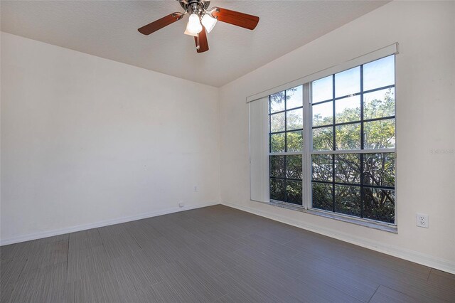 empty room with ceiling fan and a textured ceiling