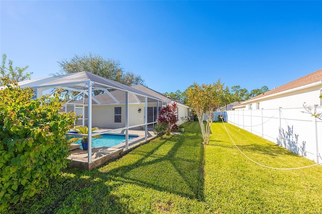 view of yard featuring a fenced in pool and a lanai