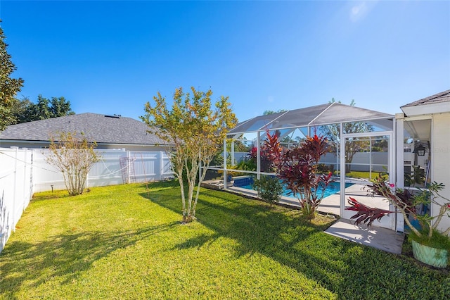 view of yard with a lanai and a fenced in pool