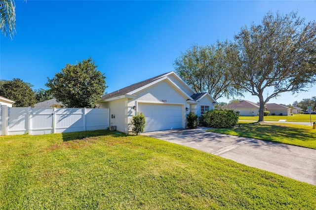 view of front of home with a front lawn and a garage