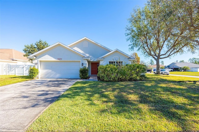 view of front of home with a garage and a front lawn