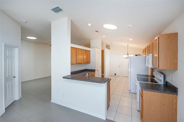 kitchen with ceiling fan, kitchen peninsula, vaulted ceiling, white appliances, and light tile patterned flooring