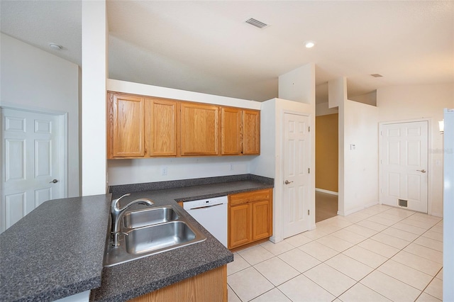 kitchen featuring dishwasher, light tile patterned floors, sink, and kitchen peninsula