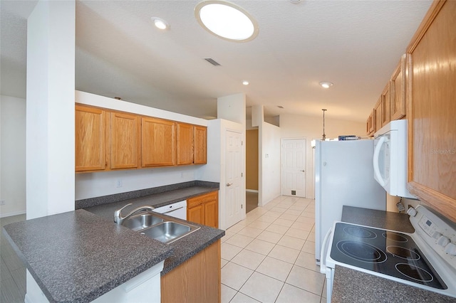 kitchen featuring kitchen peninsula, white appliances, vaulted ceiling, and sink