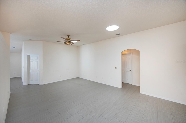 spare room featuring ceiling fan and a textured ceiling