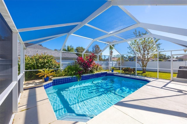 view of pool with a patio and glass enclosure