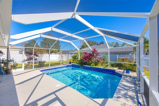 view of swimming pool with glass enclosure and a patio area