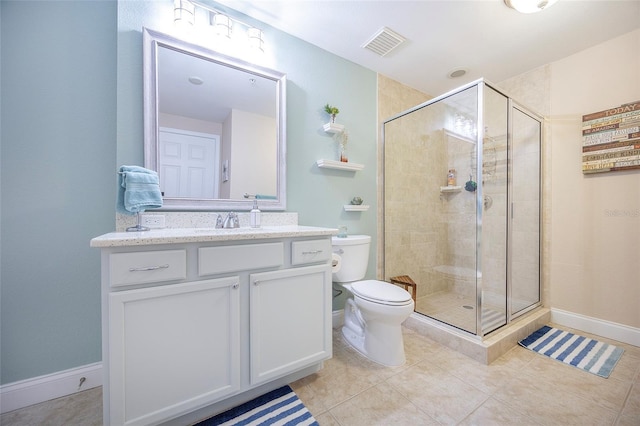 bathroom featuring tile patterned floors, vanity, toilet, and a shower with shower door