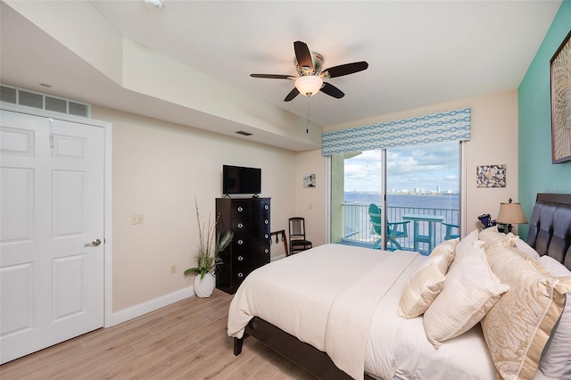 bedroom featuring ceiling fan, light hardwood / wood-style floors, and access to outside