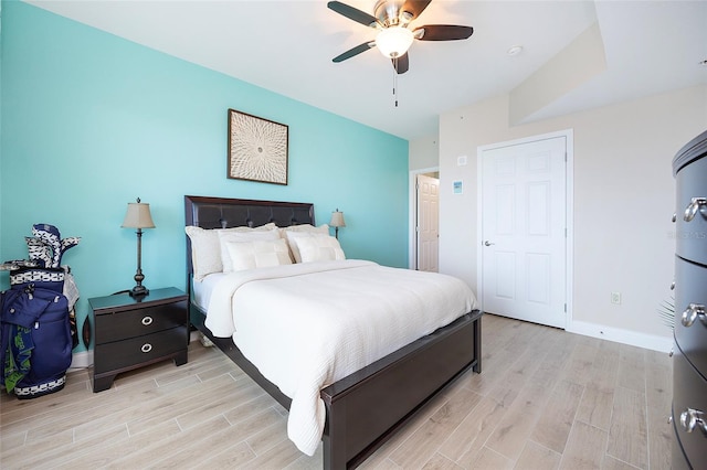 bedroom with ceiling fan and light hardwood / wood-style flooring