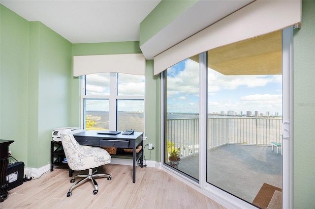 home office with a healthy amount of sunlight and light wood-type flooring