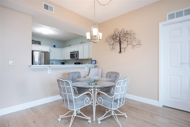 dining room featuring a chandelier and light hardwood / wood-style floors