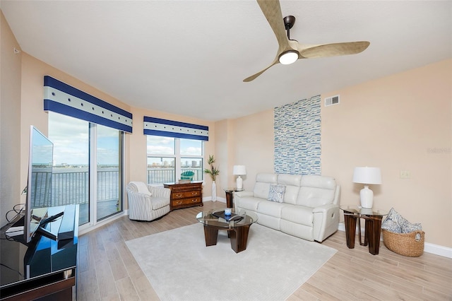 living room featuring ceiling fan and wood-type flooring