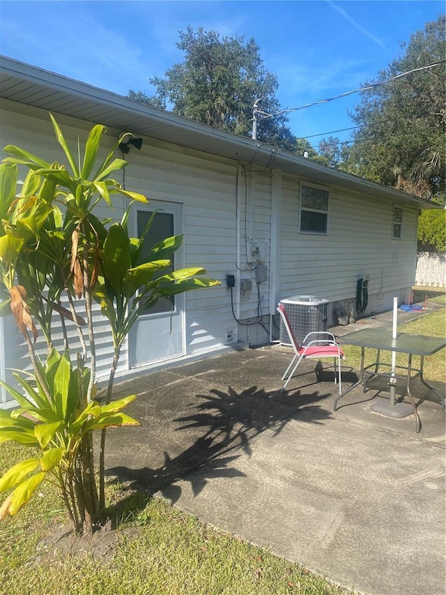 back of house with central AC and a patio area