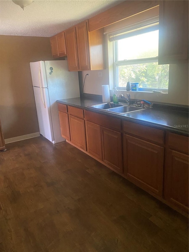 2017 Royal Palm Dr, Edgewater, FL 32141 - kitchen featuring dark hardwood / wood-style flooring, white fridge, sink, and a textured ceiling