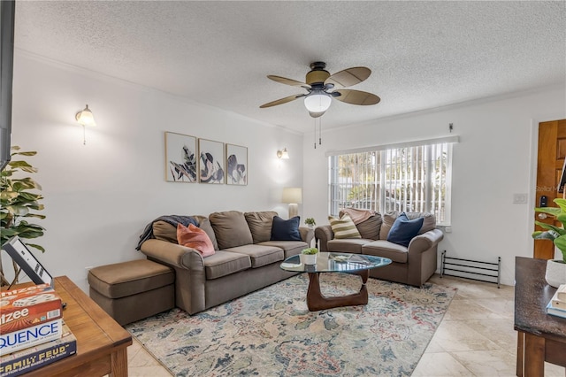 living room featuring ceiling fan and a textured ceiling