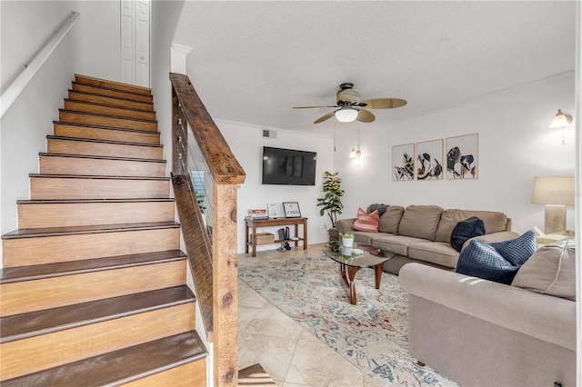 living room featuring light tile patterned floors, a textured ceiling, and ceiling fan