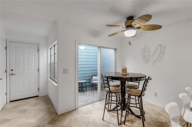 dining room with ceiling fan and a textured ceiling