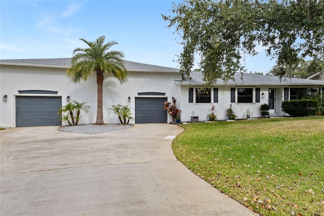 single story home with a front yard and a garage