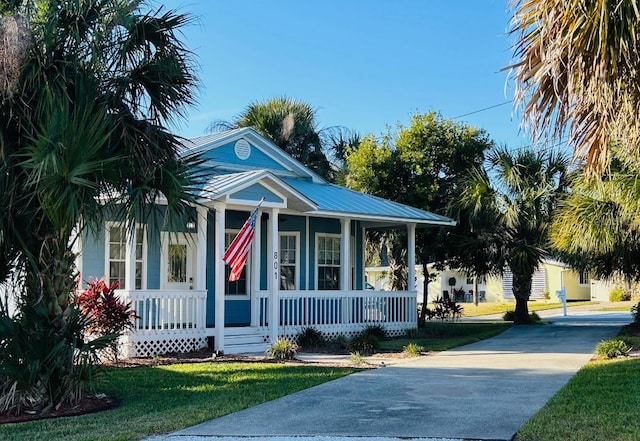 view of front of property featuring covered porch and a front lawn