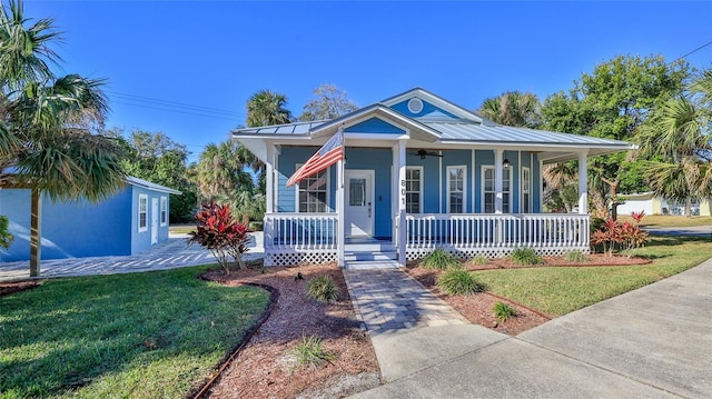 view of front of home with covered porch and a front lawn