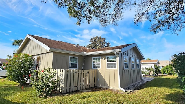 view of side of home featuring a lawn