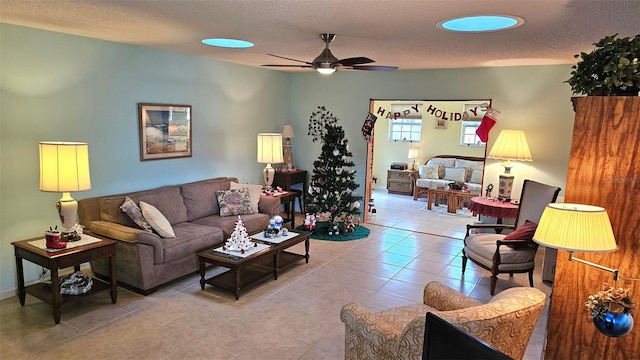 tiled living room featuring a textured ceiling and ceiling fan