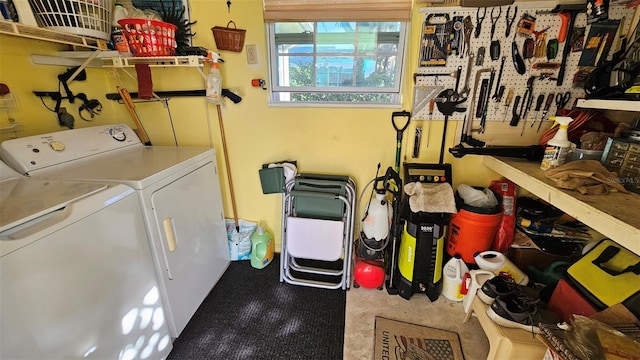 laundry room with a workshop area and independent washer and dryer