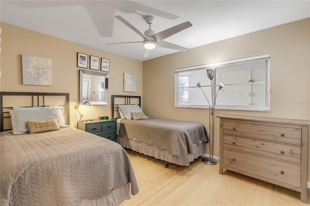 bedroom with ceiling fan and light hardwood / wood-style floors