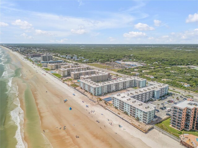 drone / aerial view featuring a beach view and a water view