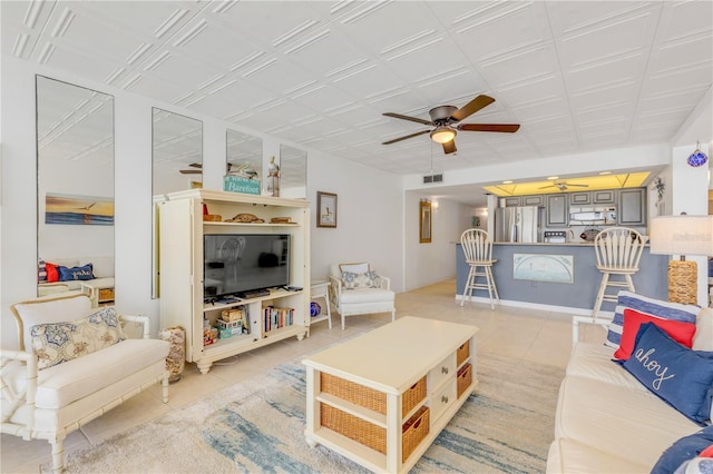 tiled living room with ceiling fan