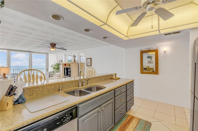 kitchen with floor to ceiling windows, sink, light tile patterned floors, a water view, and dishwasher