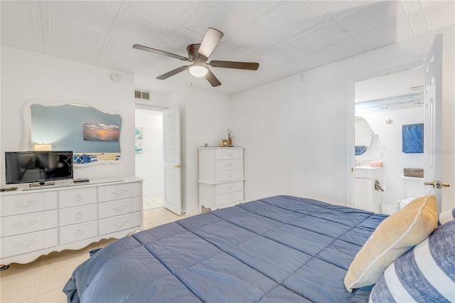 bedroom featuring connected bathroom, ceiling fan, and light tile patterned floors